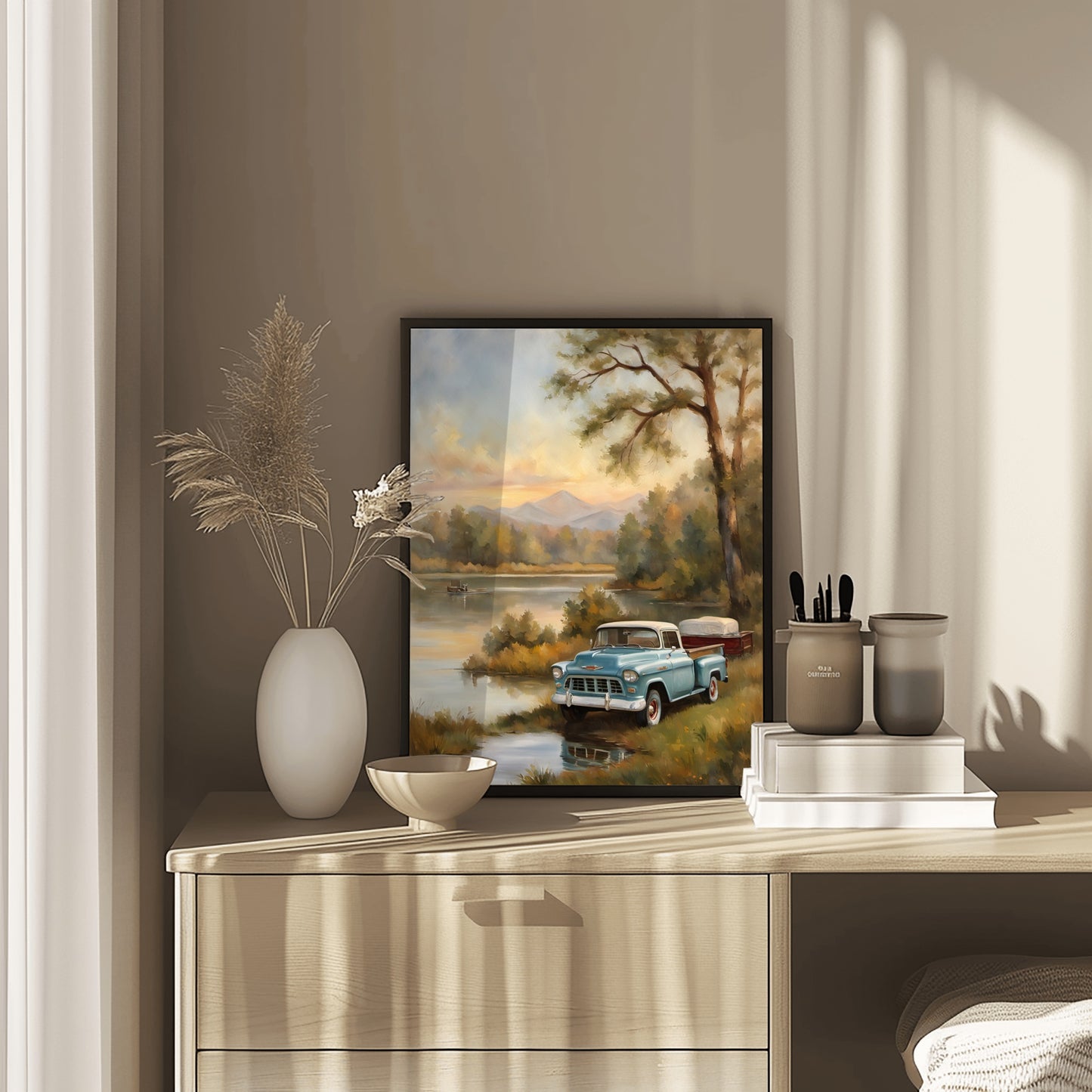1950s lakeside painting of a vintage blue truck by the water displayed on a wooden dresser