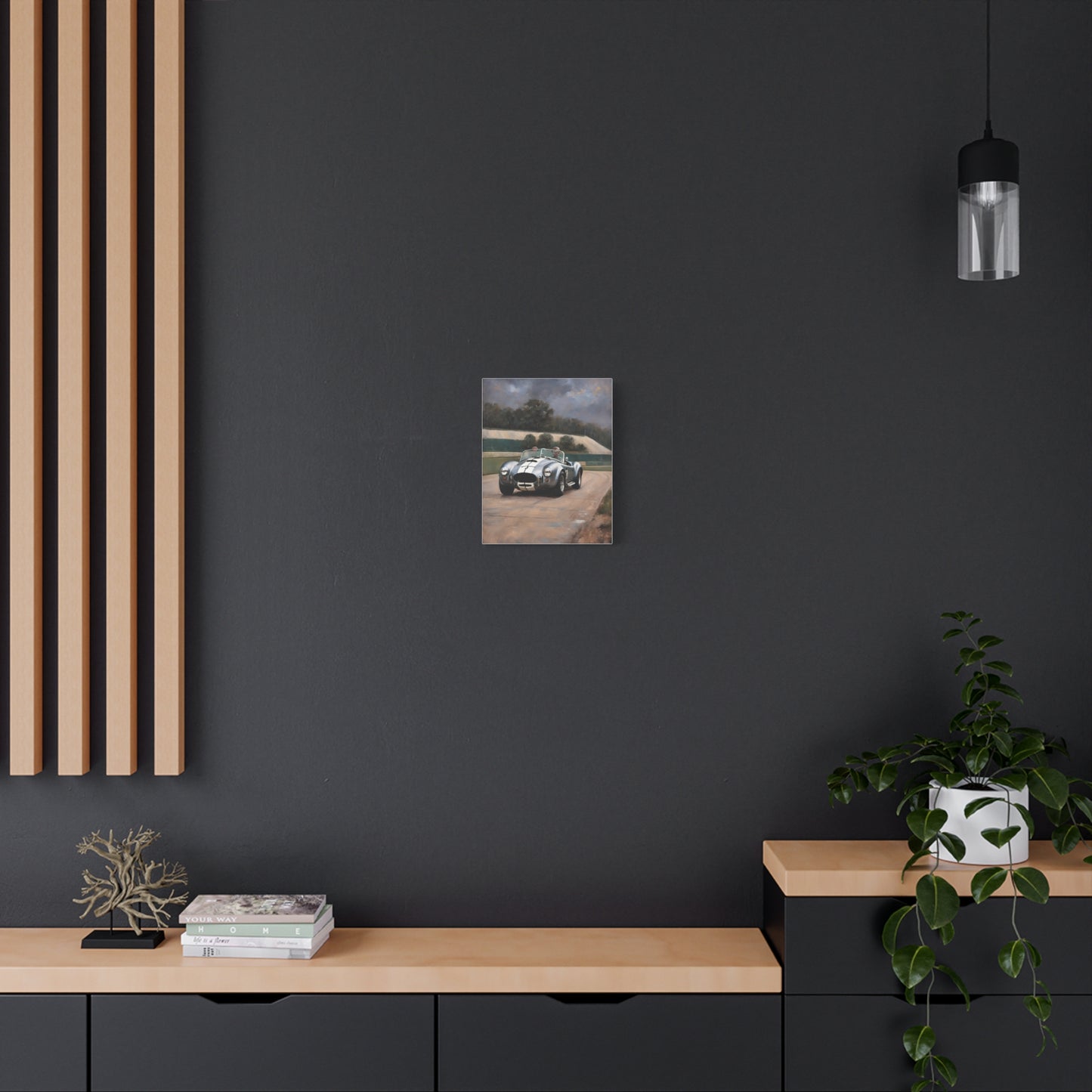 Classic Car Canvas Print hanging on a dark wall above modern wood furniture