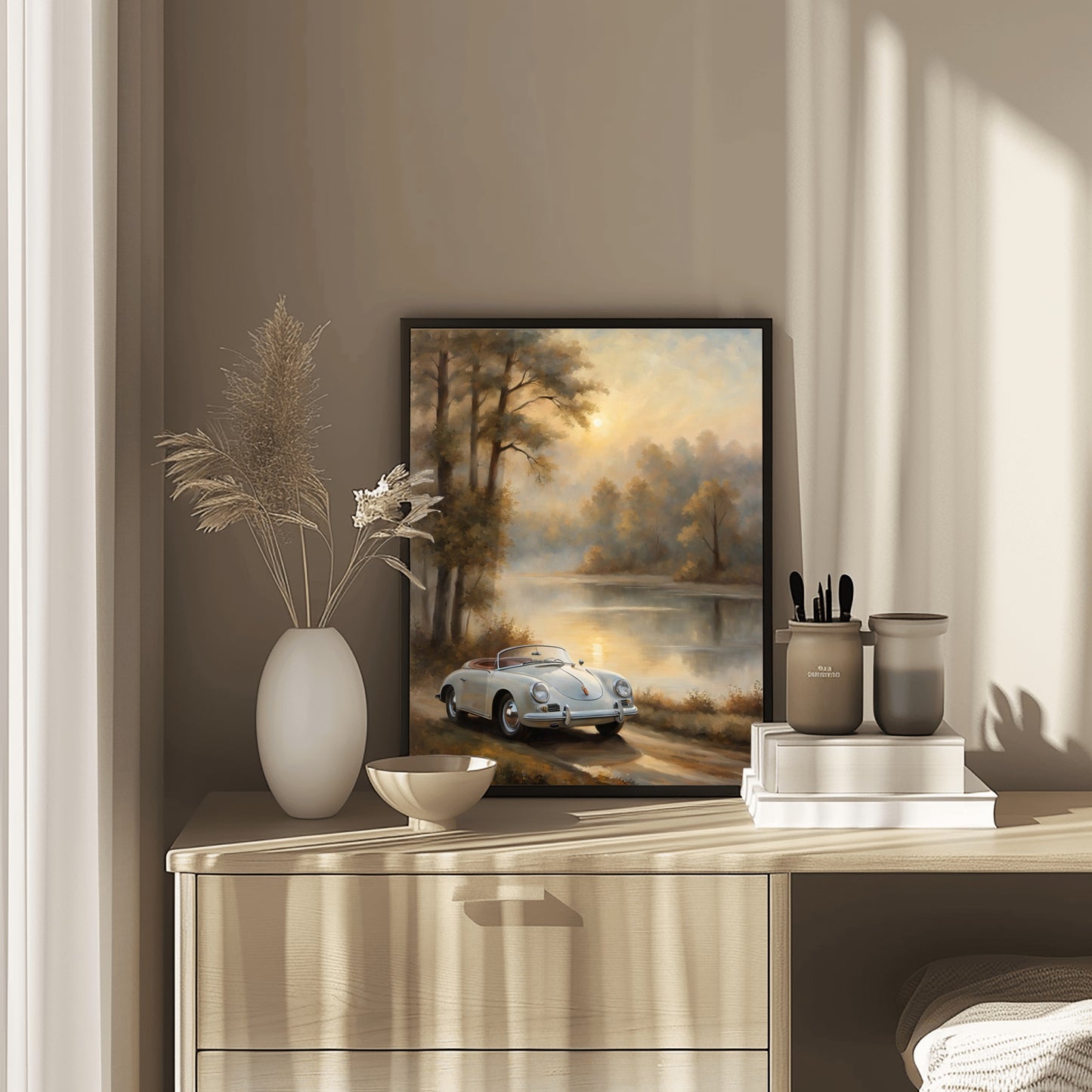 Vintage lakeside artwork featuring a classic car by a serene lake displayed on a wooden dresser