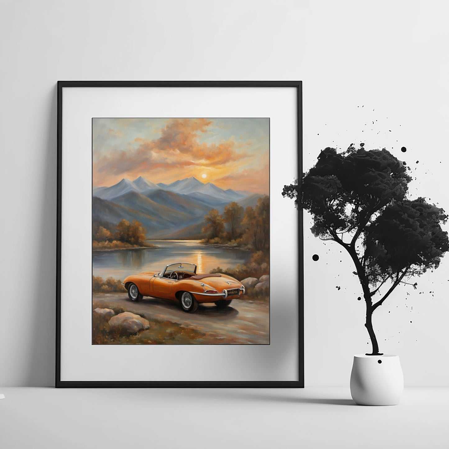 Framed lakeside sunset wall art featuring a classic orange convertible car by the lake with mountains in the background