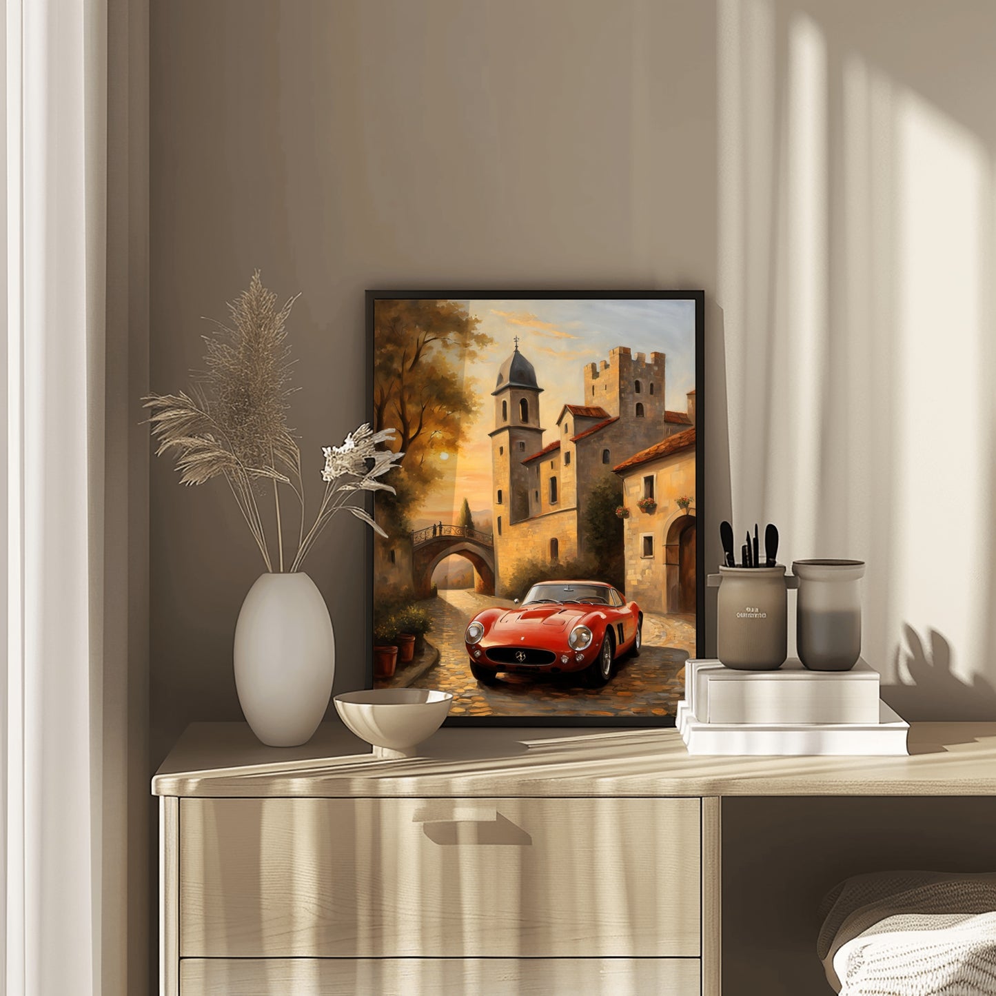 Luxury vintage art print of a red classic car in a European village displayed on a wooden dresser