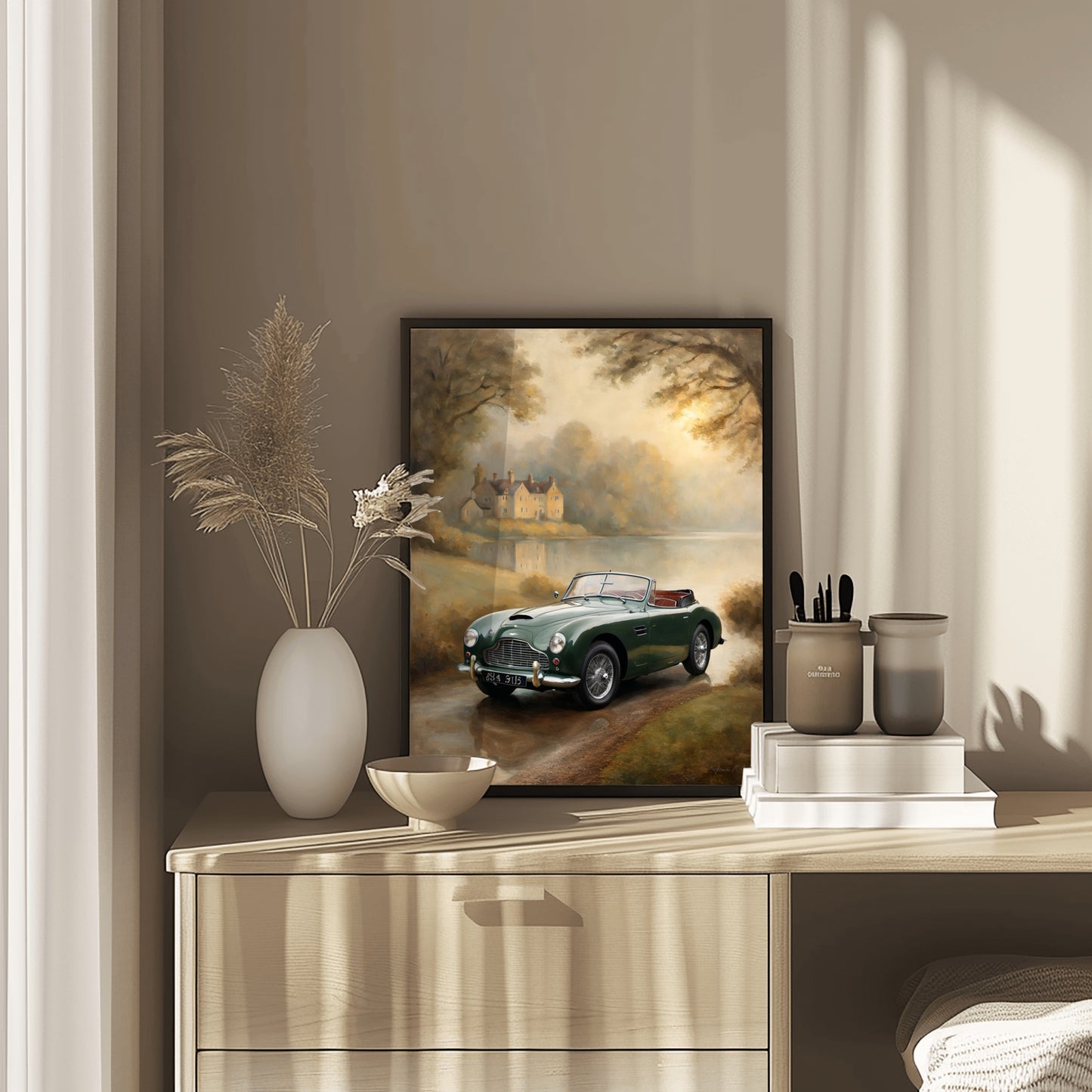 Misty lakeside vintage car print by AquilVision displayed on a beige dresser with decorative vases and books