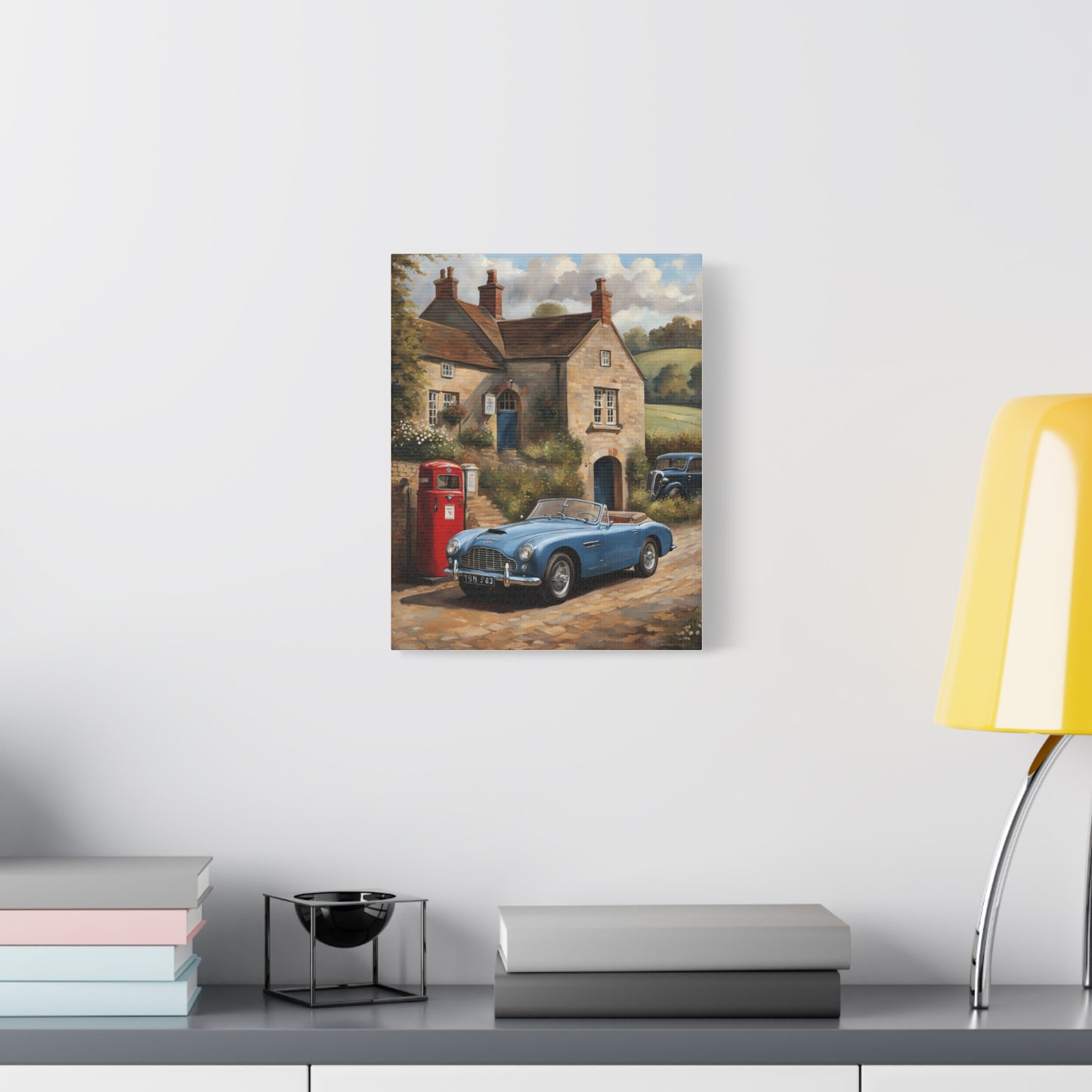 Old Car Canvas Print featuring a vintage blue car parked near a cozy cottage and red phone booth