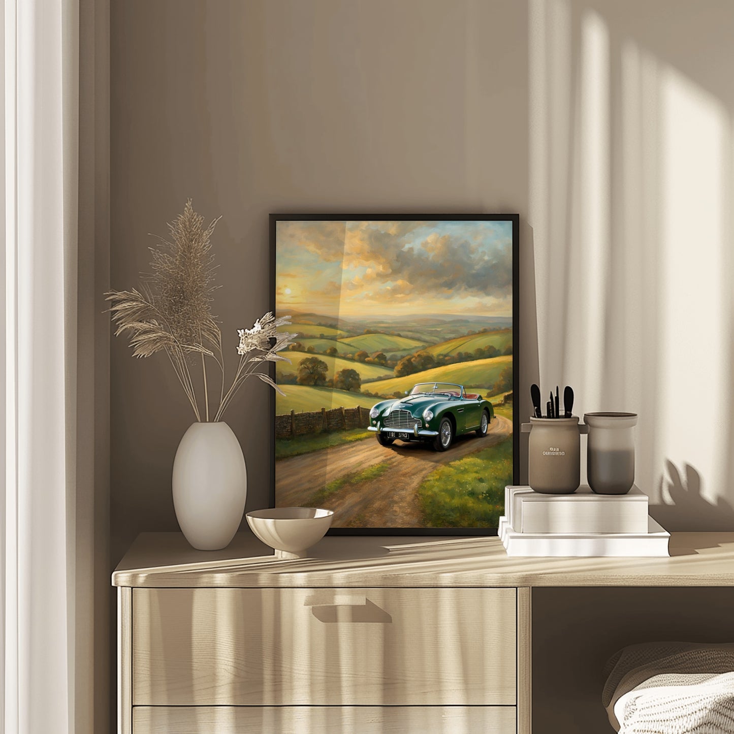 Framed vintage car sunset artwork digital print displayed on a wooden dresser with decorative items
