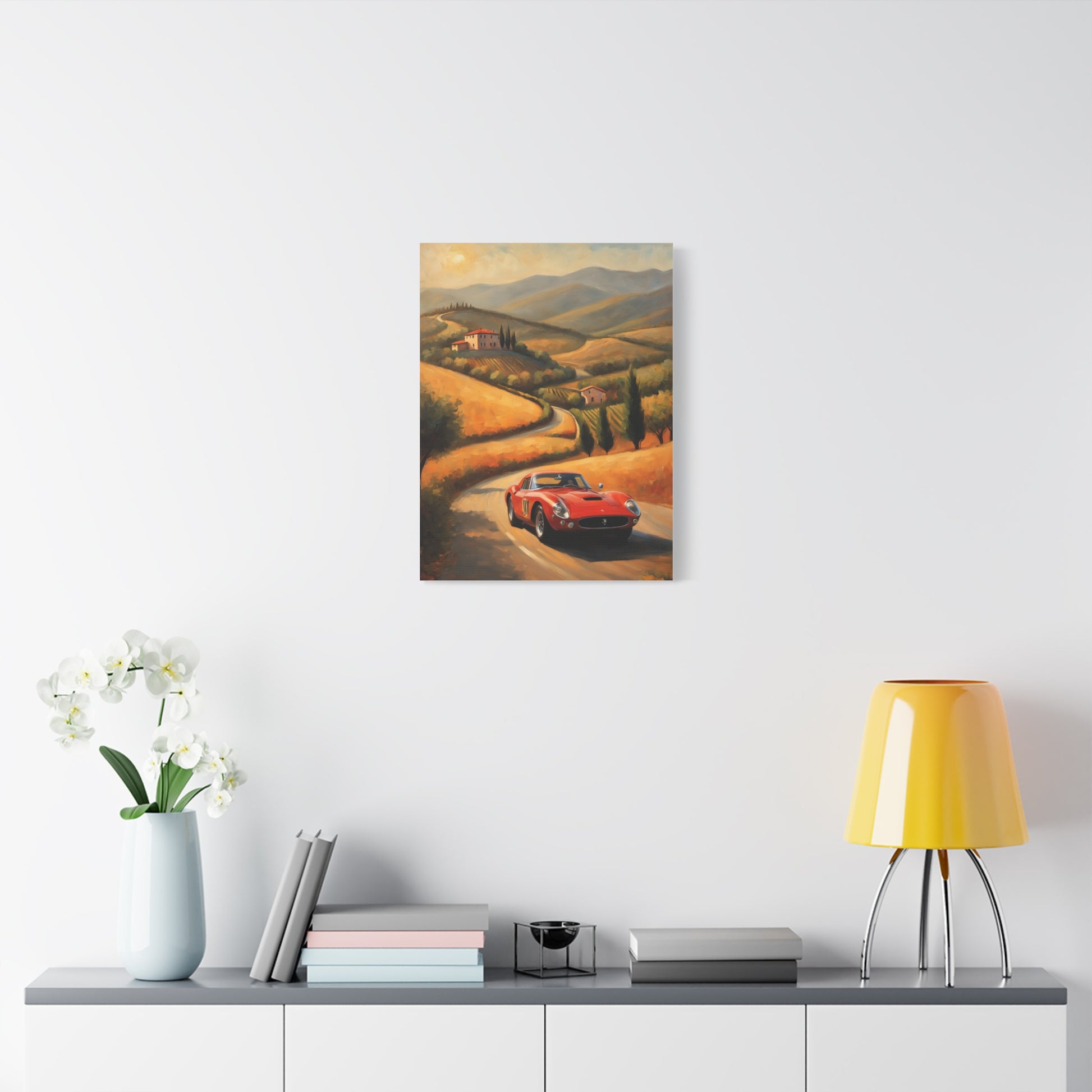 Vintage Classic Car Canvas Wall Art featuring a red car on a winding road in scenic hills