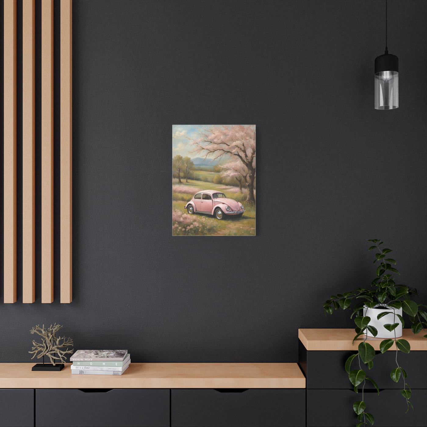Pink vintage car canvas art displayed on a modern wall with wooden slats and decorative plants