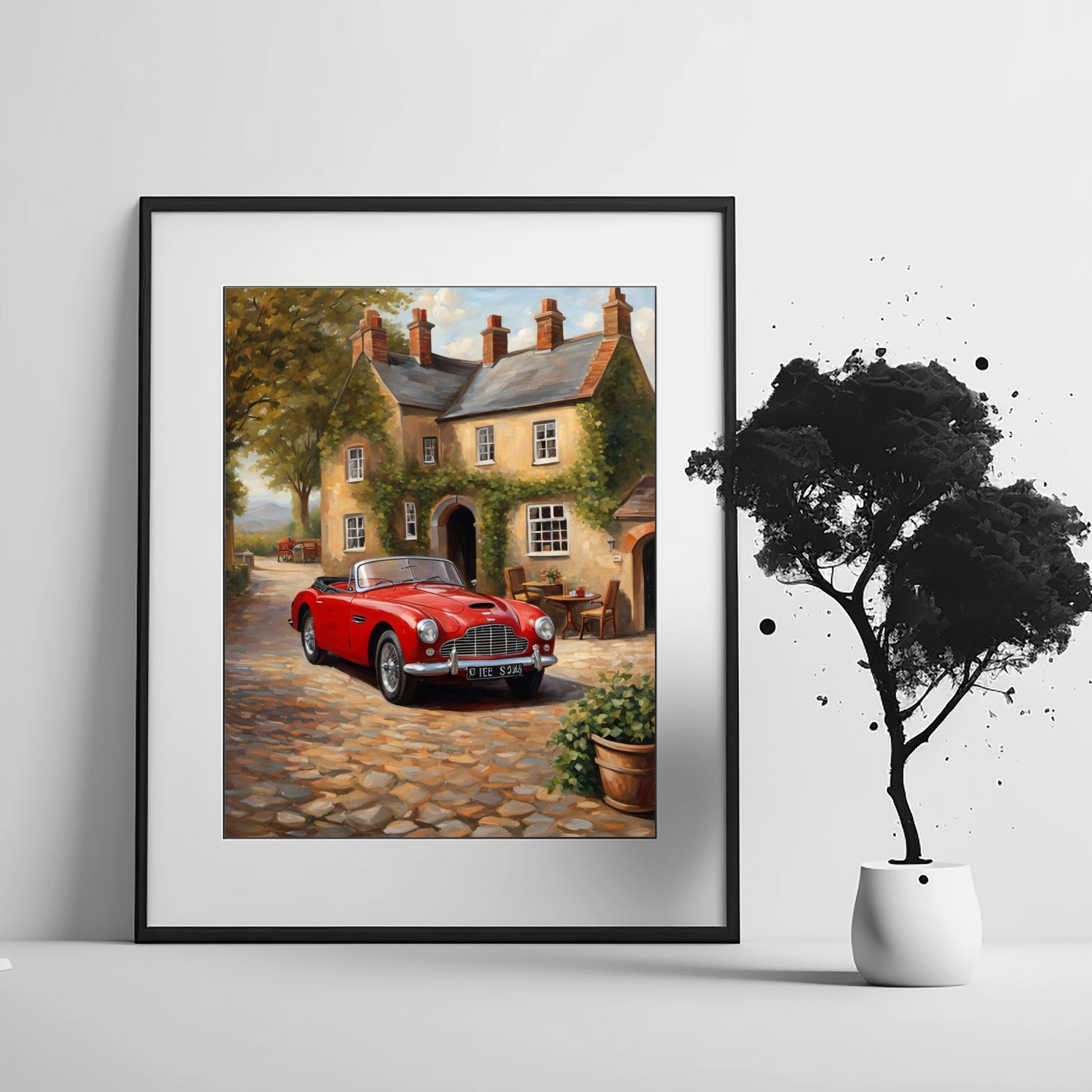 1950s convertible wall art featuring a red classic car in front of a vintage cottage on a cobblestone street