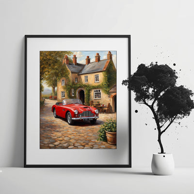 1950s convertible wall art featuring a red classic car in front of a vintage cottage on a cobblestone street