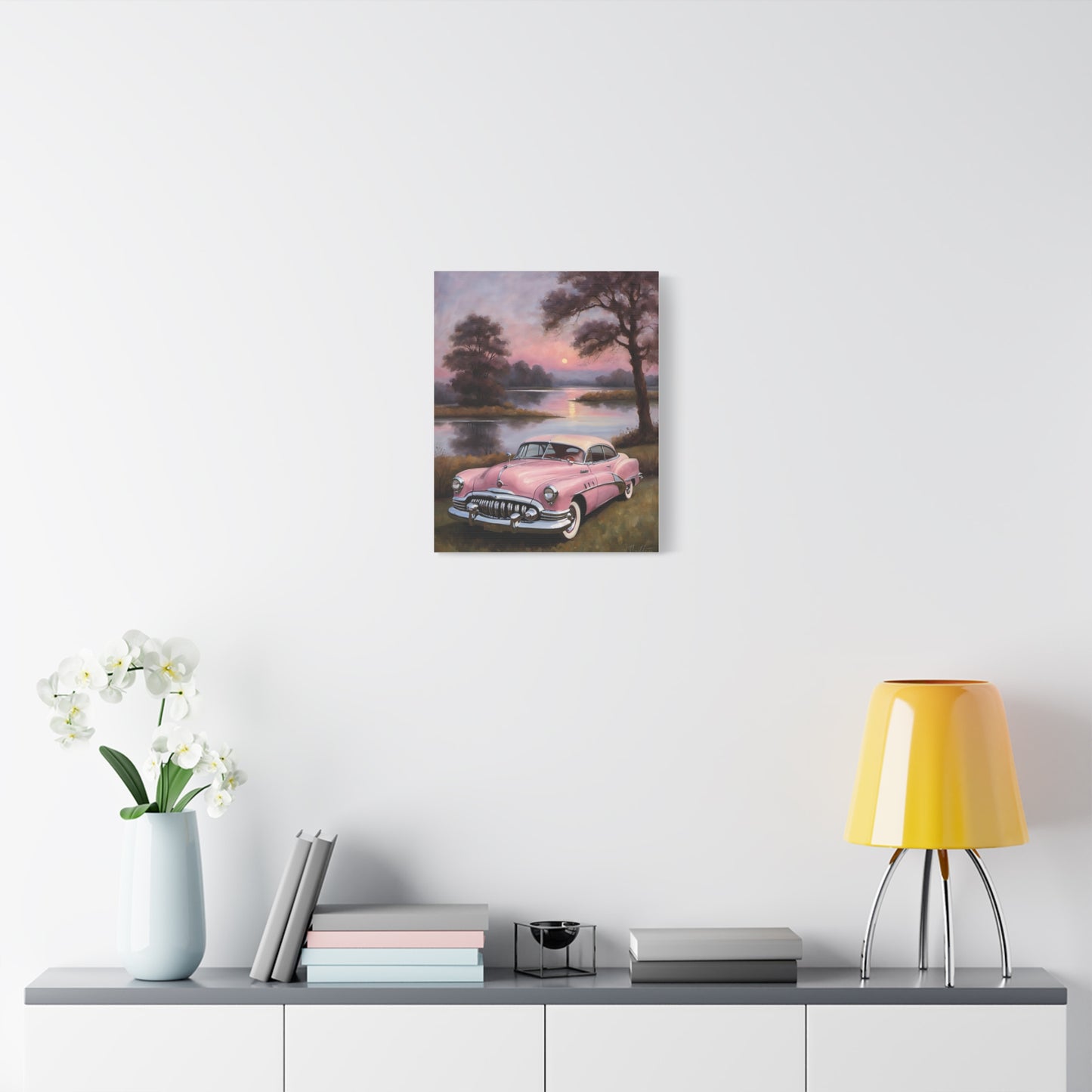 Vintage Car Canvas Art Prints featuring a classic pink car beside a serene lake at sunset