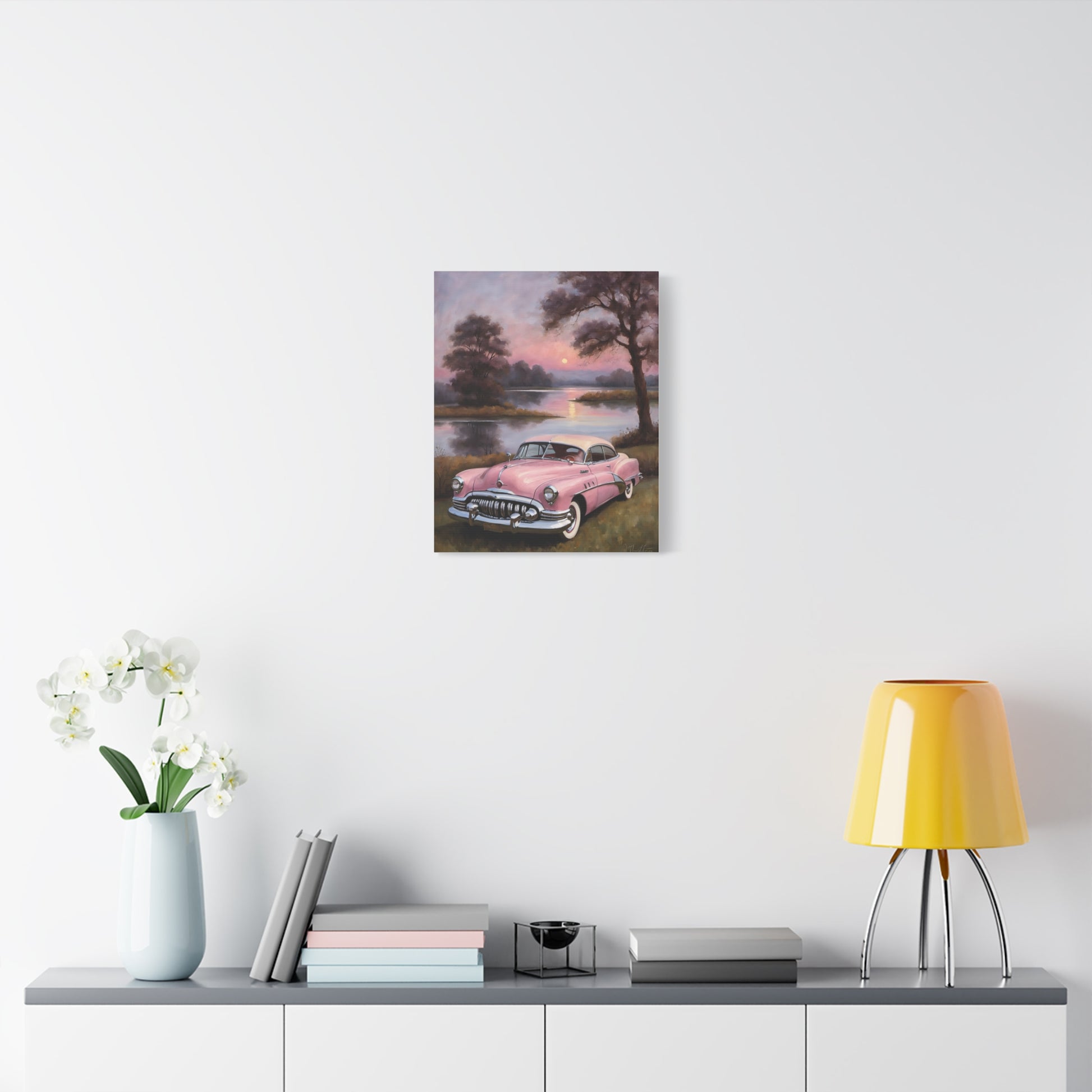 Vintage Car Canvas Art Prints featuring a classic pink car beside a serene lake at sunset