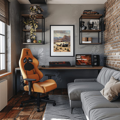 Desert highway wall art featuring a vintage car in a desert landscape above a modern workspace with gaming chair and gray sofa