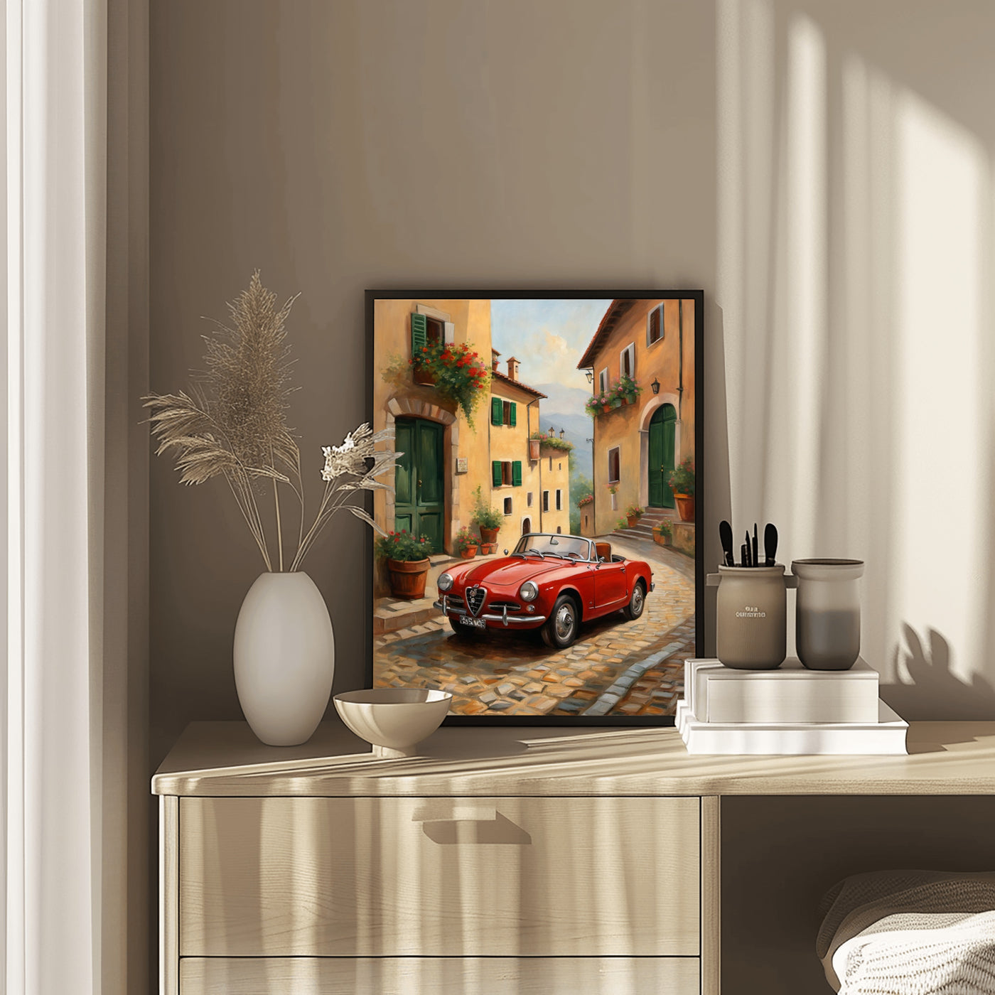 Vintage car home decor print featuring a red classic car on a cobblestone street in a warm-toned village scene