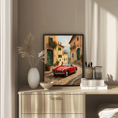 Vintage car home decor print featuring a red classic car on a cobblestone street in a warm-toned village scene