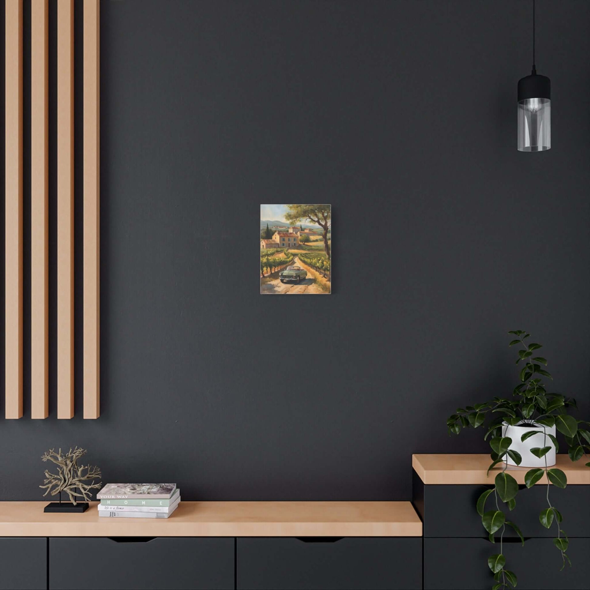 Vintage car landscape canvas art displayed on a dark wall above a wooden sideboard
