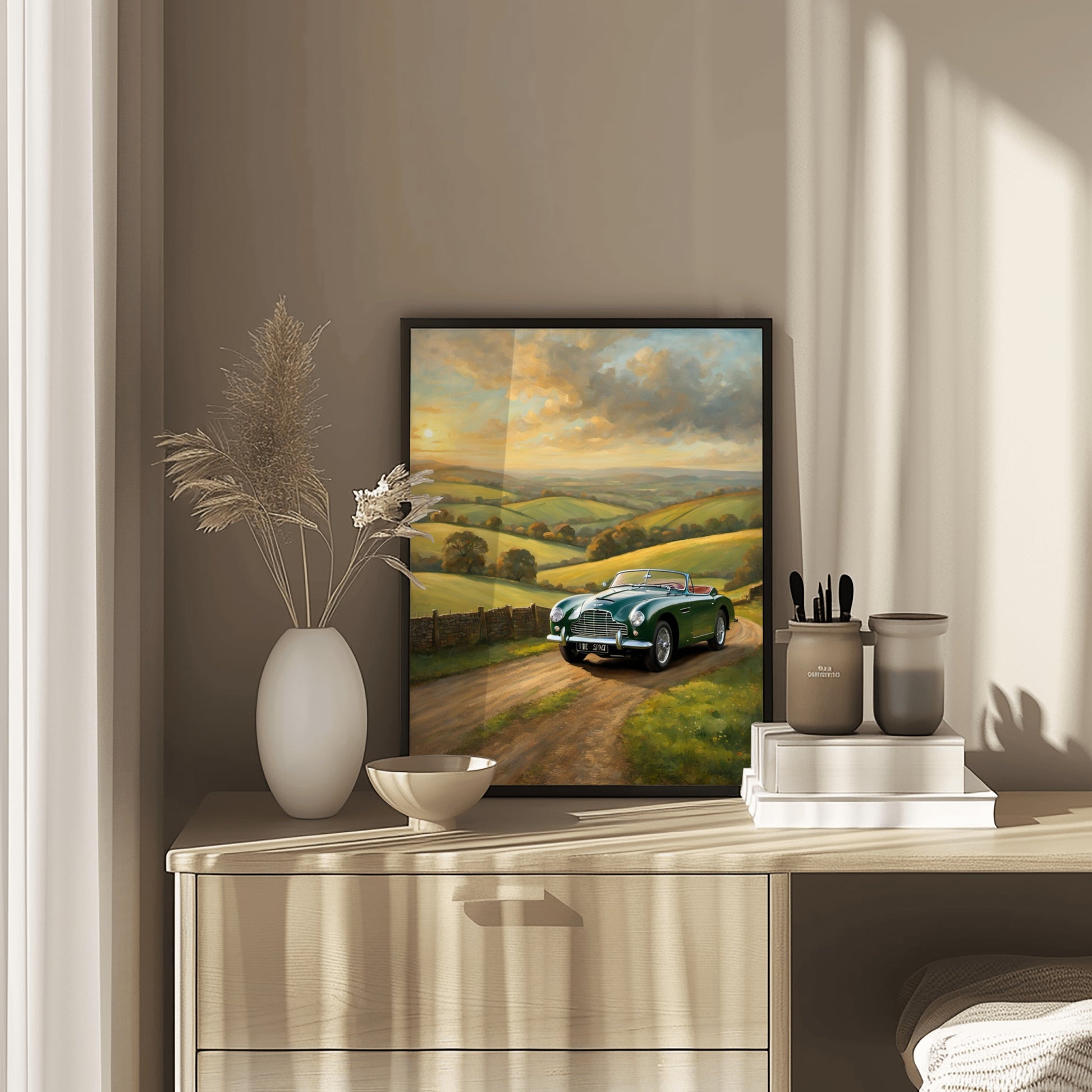 Framed vintage car sunset artwork digital print displayed on a wooden dresser with decorative items
