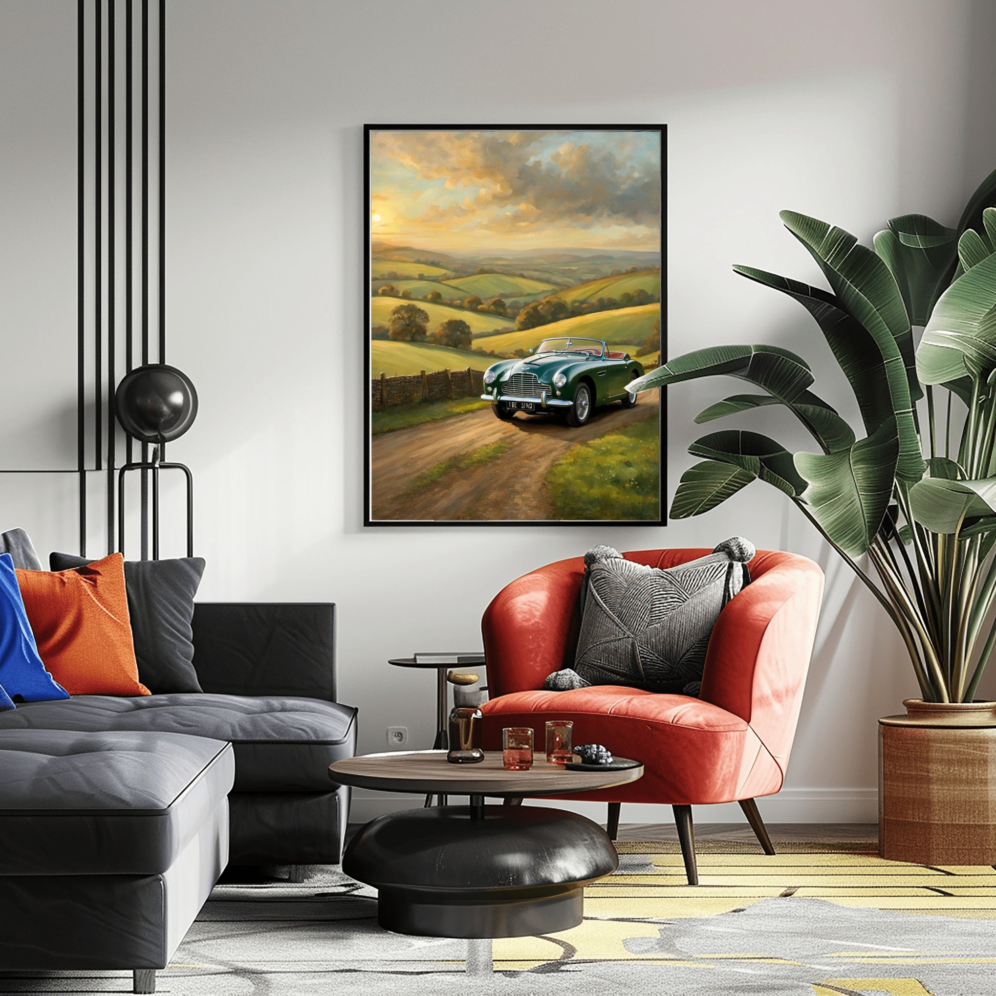 Vintage car sunset artwork by AquilVision displayed in a modern living room with black sofa and orange chair